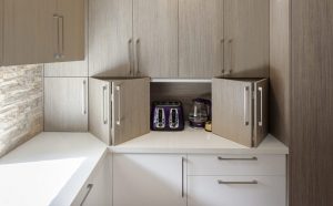 Custom kitchen, pocket doors, bi-fold kitchen doors, stone bench-top, kitchen handles, bespoke cabinets